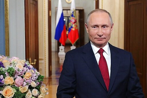 Russian President Vladimir Putin speaks to celebrate International Women's Day, in Moscow, Russia, Sunday, March 8, 2020. International Women's Day on March 8 is an official holiday in Russia, where men traditionally give flowers and gifts to female relatives, friends and colleagues. (Mikhail Klimentyev, Sputnik, Kremlin Pool Photo via AP)