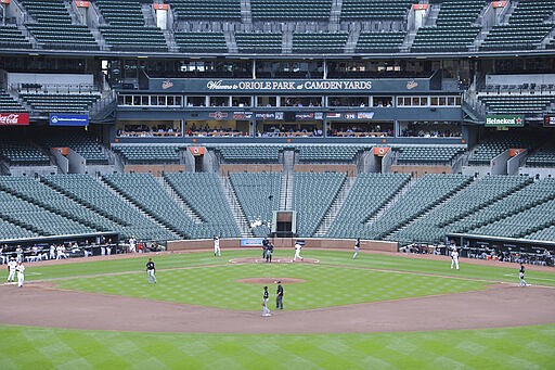 FILE - In this April 29, 2015, file photo, Baltimore Orioles' Caleb Joseph connects for a single against the Chicago White Sox in Baltimore. Jeff Samardzija pitched for the White Sox in the game at Camden Yards closed to fans because of rioting in Baltimore prompted by the death of Freddie Gray, a 25-year-old black man who died in police custody. U.S. sports leaders are now weighing whether to bar fans from ballparks and stadiums to help stall the coronavirus outbreak. (AP Photo/Gail Burton, File)