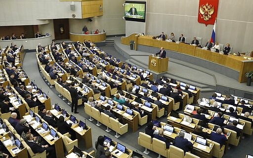 Russian Communist Party leader Gennady Zyuganov, on the podium, speaks during a session prior to voting for constitutional amendments at the State Duma, the Lower House of the Russian Parliament in Moscow, Russia, Tuesday, March 10, 2020. The sweeping reform is widely seen as part of the effort by Putin, who has has to step down in 2024 after having served the two consecutive terms that the country's constitution currently allows, to stay in on power. (AP Photo/Pavel Golovkin)