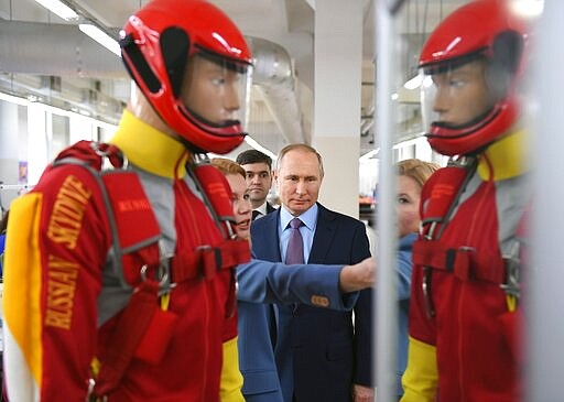 Russian President Vladimir Putin, center, visits the Ivanovo Parachute Plant in Ivanovo, 254 kilometers (158 miles) northeast of Moscow, Russia, Friday, March 6, 2020. (Alexei Nikolsky, Sputnik, Kremlin Pool Photo via AP)