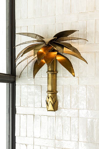 This 2019 photo shows the inside of andSons Chocolatiers in Beverly Hills, Calif., which was designed by Lauren Buxbaum Gordon and Nate Berkus. Buxbaum Gordon says homeowners seeking the perfect tile for a bathroom or backsplash may find inspiration in public spaces., like the tile wall here at andSons. (Christopher Dibble via AP)