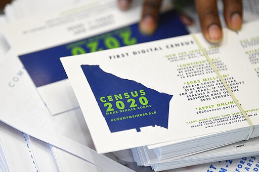 FILE - In this Aug. 13, 2019, file photo, a worker gets ready to pass out instructions on how to fill out the 2020 census during a town hall meeting in Lithonia, Ga. Although the 2020 census kicked off in rural villages of Alaska in January, the rest of the nation gets to start participating in the once-a-decade head count in the coming days.   (AP Photo/John Amis, File)