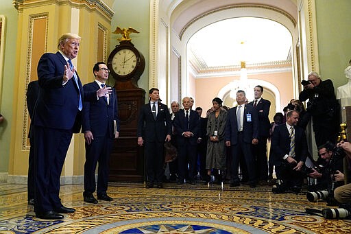 President Donald Trump talks to reporters about coronavirus after meeting with lawmakers on Capitol Hill, Tuesday, March 10, 2020, in Washington. (AP Photo/Evan Vucci)