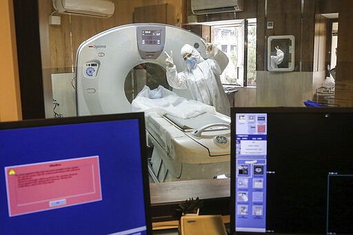 In this Saturday, March 7, 2020, a medic wearing protective gear flashes victory sign while working in a ward dedicated for people infected with the new coronavirus, at Baqiyatallah Al'Azam Hospital affiliated to the Revolutionary Guard, in Tehran, Iran. Iran is the hardest-hit country in the Mideast by the new coronavirus. The vast majority of people recover from the new virus. (Mohammad Hasan Zarifmanesh/Tasnim News Agency via AP)