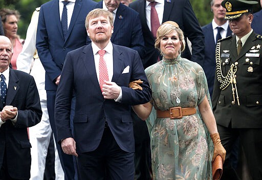 King Willem-Alexander of the Netherlands, left, walks with his wife Queen Maxima during their visit at a Dutch war cemetery in Jakarta, Indonesia, Tuesday, March 10, 2020. The Dutch royal couple are currently on on a five-day visit in the country. (AP Photo/Dita Alangkara)