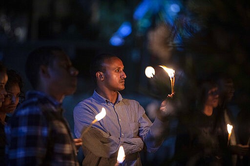 Colleagues and relatives light candles in tribute at a memorial service for the crew of Ethiopian Airlines Flight ET302, held at the Ethiopian Pilots Association in the capital Addis Ababa, in Ethiopia Tuesday, March 10, 2020. Relatives and colleagues gathered Tuesday to remember those who died one year ago when the jet crashed killing all 157 on board. (AP Photo/Mulugeta Ayene)