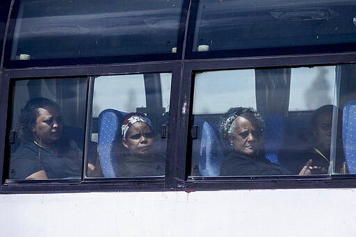 Relatives in buses arrive to attend the memorial service for the one-year anniversary of the crash of Ethiopian Airlines Flight ET302 in the rural Tulufera area near Bishoftu, south-east of the capital Addis Ababa, in Ethiopia Tuesday, March 10, 2020. Grim-faced, visibly grief-stricken, some crying, hundreds of family members gathered Tuesday for a memorial service at the site where one year ago the jet crashed into the rocky ground, killing all 157 on board. (AP Photo/Mulugeta Ayene)