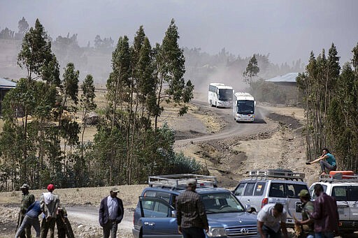 Relatives in buses arrive to attend the memorial service for the one-year anniversary of the crash of Ethiopian Airlines Flight ET302 in the rural Tulufera area near Bishoftu, south-east of the capital Addis Ababa, in Ethiopia Tuesday, March 10, 2020. Grim-faced, visibly grief-stricken, some crying, hundreds of family members gathered Tuesday for a memorial service at the site where one year ago the jet crashed into the rocky ground, killing all 157 on board. (AP Photo/Mulugeta Ayene)