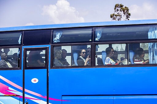 Relatives in buses arrive to attend the memorial service for the one-year anniversary of the crash of Ethiopian Airlines Flight ET302 in the rural Tulufera area near Bishoftu, south-east of the capital Addis Ababa, in Ethiopia Tuesday, March 10, 2020. Grim-faced, visibly grief-stricken, some crying, hundreds of family members gathered Tuesday for a memorial service at the site where one year ago the jet crashed into the rocky ground, killing all 157 on board. (AP Photo/Mulugeta Ayene)