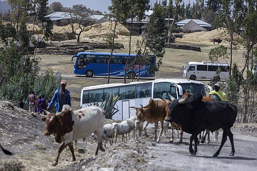 Relatives in buses arrive to attend the memorial service for the one-year anniversary of the crash of Ethiopian Airlines Flight ET302 in the rural Tulufera area near Bishoftu, south-east of the capital Addis Ababa, in Ethiopia Tuesday, March 10, 2020. Grim-faced, visibly grief-stricken, some crying, hundreds of family members gathered Tuesday for a memorial service at the site where one year ago the jet crashed into the rocky ground, killing all 157 on board. (AP Photo/Mulugeta Ayene)