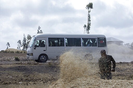 Relatives in buses arrive to attend the memorial service for the one-year anniversary of the crash of Ethiopian Airlines Flight ET302 in the rural Tulufera area near Bishoftu, south-east of the capital Addis Ababa, in Ethiopia Tuesday, March 10, 2020. Grim-faced, visibly grief-stricken, some crying, hundreds of family members gathered Tuesday for a memorial service at the site where one year ago the jet crashed into the rocky ground, killing all 157 on board. (AP Photo/Mulugeta Ayene)