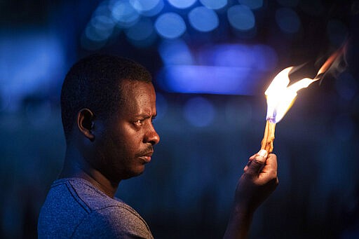 Colleagues and relatives light candles in tribute at a memorial service for the crew of Ethiopian Airlines Flight ET302, held at the Ethiopian Pilots Association in the capital Addis Ababa, in Ethiopia Tuesday, March 10, 2020. Relatives and colleagues gathered Tuesday to remember those who died one year ago when the jet crashed killing all 157 on board. (AP Photo/Mulugeta Ayene)