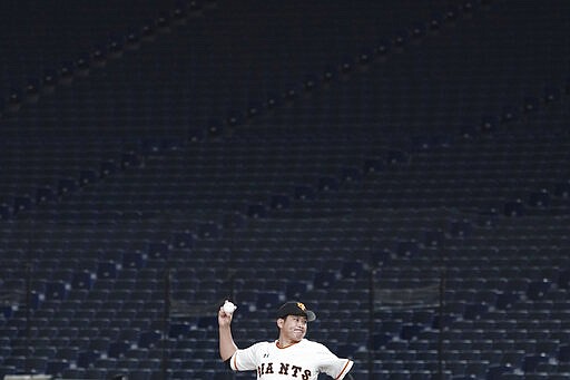 FILE - In this Feb. 29, 2020, file photo, Tomoyuki Sugano of the Yomiuri Giants pitches with a backdrop of empty stands during play in a preseason baseball game between the Yomiuri Giants and the Yakult Swallows at Tokyo Dome in Tokyo. The tentacles of cancelling the Tokyo Olympics &#151; or postponing or staging it in empty venues &#151; would reach into every corner of the globe, much like the spreading virus that now imperils the opening ceremony on July 24. (AP Photo/Eugene Hoshiko, File)