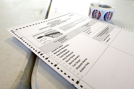 A Democratic presidential primary ballot sits next to a roll of &quot;I Voted&quot; stickers in Jackson, Miss., Tuesday, March 10, 2020. Mississippi is one of several states holding presidential party primaries today. (AP Photo/Rogelio V. Solis)