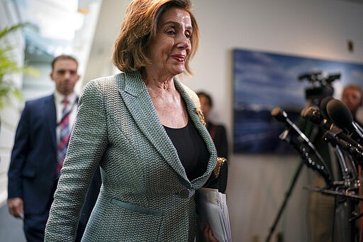 Speaker of the House Nancy Pelosi, D-Calif., returns to her office after meeting with fellow Democrats, on Capitol Hill in Washington, Tuesday, March 10, 2020. President Donald Trump says his administration will ask Congress to pass payroll tax relief as he looks to calm financial markets' fears over the impact of the coronavirus epidemic. (AP Photo/J. Scott Applewhite)