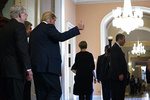 President Donald Trump walks with Senate Majority Leader Mitch McConnell of Ky., to a meeting with lawmakers on Capitol Hill, Tuesday, March 10, 2020, in Washington. (AP Photo/Evan Vucci)