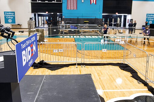 Workers take down chairs after a campaign rally for Democratic presidential candidate former Vice President Joe Biden was cancelled at Cuyahoga Community College Tuesday, March 10, 2020, in Cleveland, due to health concerns with the coronavirus. (AP Photo/Phil Long)