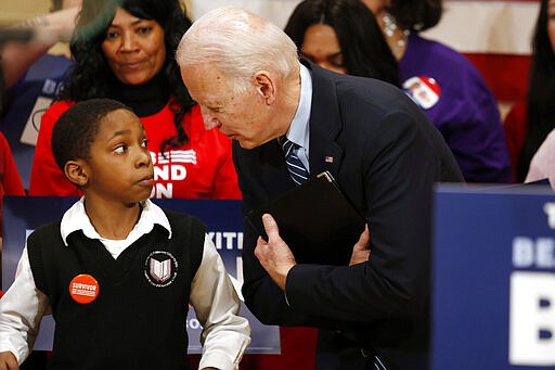 Democratic presidential candidate former Vice President Joe Biden, right, speaks with Deaunte Bell Jr., 11, of Columbus, Ohio, at a campaign event in Columbus, Ohio, Tuesday, March 10, 2020. (AP Photo/Paul Vernon)