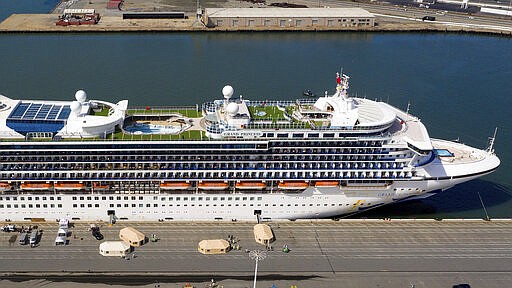 Tents stand on a wharf near the Grand Princess at the Port of Oakland in Oakland, Calif., Monday, March 9, 2020. The cruise ship, which had maintained a holding pattern off the coast for days, is carrying multiple people who tested positive  for COVID-19, a disease caused by the new coronavirus. (AP Photo/Noah Berger)