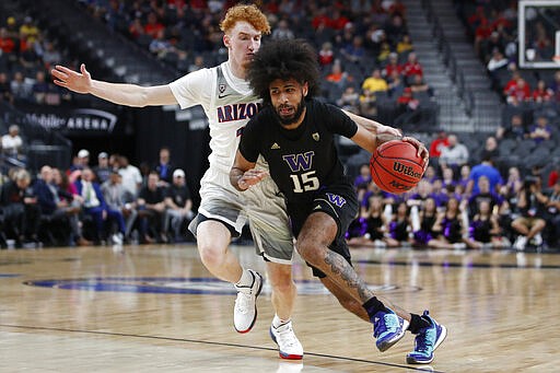 Washington's Marcus Tsohonis (15) drives around Arizona's Nico Mannion during the first half of an NCAA college basketball game in the first round of the Pac-12 men's tournament Wednesday, March 11, 2020, in Las Vegas. (AP Photo/John Locher)