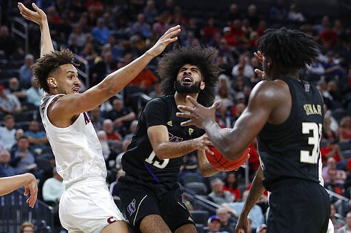 Washington's Marcus Tsohonis drives into Arizona's Chase Jeter, left, during the first half of an NCAA college basketball game in the first round of the Pac-12 men's tournament Wednesday, March 11, 2020, in Las Vegas. (AP Photo/John Locher)