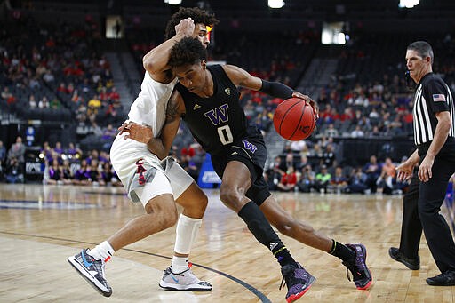 Washington's Jaden McDaniels, right, drives into Arizona's Josh Green during the first half of an NCAA college basketball game in the first round of the Pac-12 men's tournament Wednesday, March 11, 2020, in Las Vegas. (AP Photo/John Locher)