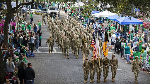 FILE - In this Saturday, March 16, 2019, file photo, members of the Georgia Southern University Army ROTC Eagle Battalion marches in the Savannah St. Patrick's Day parade, in Savannah, Ga. Business leaders in Savannah, postponed the city&#146;s 196-year-old St. Patrick&#146;s Day parade Wednesday, March 11, 2020, amid concerns about the new coronavirus hours after Gov. Brian Kemp took the extraordinary step of asking state lawmakers to approve $100 million in additional funding to help the state combat the virus. (AP Photo/Stephen B. Morton, File)