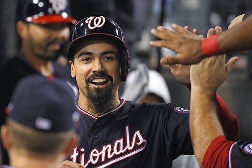 FILE - In this Oct. 9, 2019, file photo, Washington Nationals' Anthony Rendon celebrates in the dugout after scoring on a single by Juan Soto during the sixth inning in Game 5 of the baseball team's National League Division Series against the Los Angeles Dodgers in Los Angeles. The Los Angeles Angels paired Rendon, the best hitter on the free agent market, and Mike Trout, their three-time AL MVP, this winter at the heart of a lineup stocked with an array of tested veterans and promising youngsters. (AP Photo/Mark J. Terrill, File)