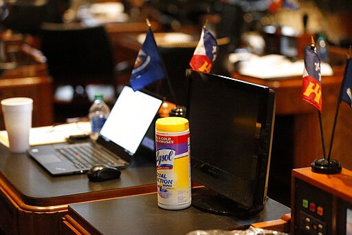 A container of disinfectant wipes sits next to the desk of Rep. Jerome Zeringue, R-Houma, during the start of the 2020 general legislative session in Baton Rouge, La., Monday, March 9, 2020. Gov. John Bel Edwards announced at the session that the state's first confirmed case of the COVID-19 Coronavirus was discovered today in Jefferson Parish. (AP Photo/Gerald Herbert)