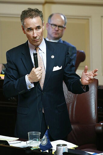 In this Wednesday, March 4, 2020 photo, State Sen. Joe Morrissey, D-Richmond, gestures during the Senate session at the Capitol in Richmond, Va.  Morrissey, who calls himself &quot;Fighting Joe,&quot; has pushed his way back into the political fold. (AP Photo/Steve Helber)