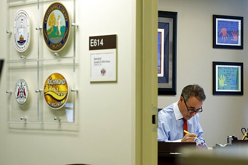 In this Thursday, March 5, 2020 photo, Virginia State Sen. Joe Morrissey, D-Richmond, works in his office at the Capitol in Richmond, Va. The former prosecutor-turned-defense attorney, who calls himself &quot;Fighting Joe,&quot; has pushed his way back into the political fold. (AP Photo/Steve Helber)