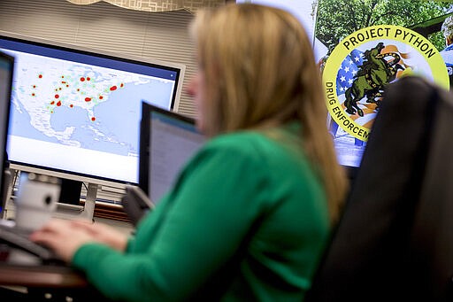 Drug Enforcement Administration agents and intelligence analysts gather information from field operations across the country at their command center in Chantilly, Va., Wednesday, March 11, 2020, as &quot;Project Python&quot; coordinates arrests simultaneously across the country.  (AP Photo/Andrew Harnik)