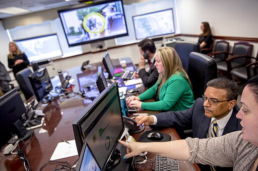 Drug Enforcement Administration agents and intelligence analysts gather information from field operations across the country at their command center in Chantilly, Va., Wednesday, March 11, 2020, as &quot;Project Python&quot; coordinates arrests simultaneously across the country.  (AP Photo/Andrew Harnik)