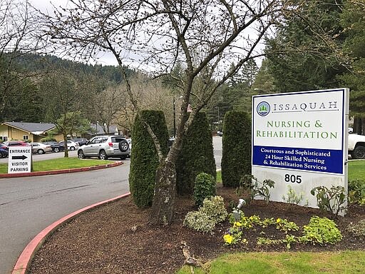 The visitor entrance is seen to the Issaquah Nursing and Rehabilitation Center in Issaquah, east of Seattle, the site of the latest death from the new coronavirus in Washington state on Tuesday, March 10, 2020. The Issaquah Nursing and Rehabilitation Center on Tuesday, announced that five residents and two staff have tested positive for the new coronavirus. They said a resident also died over the weekend. (AP Photo/Martha Bellisle)