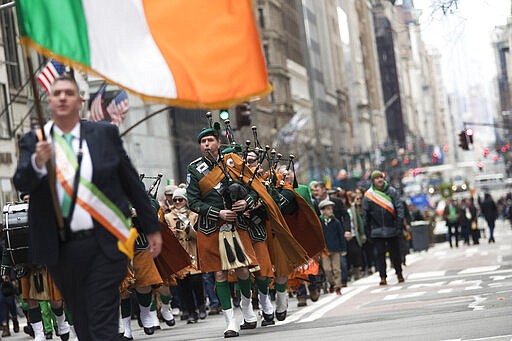 FILE - In this Saturday, March 16, 2019, file photo, bagpipers and others march up Fifth Avenue during the St. Patrick's Day Parade in New York. The New York City St. Patrick&#146;s Day Parade has been postponed for the first time in its 258-year history because of coronavirus concerns, Gov. Andrew Cuomo announced Wednesday, March 11, 2020. (AP Photo/Mary Altaffer, File)