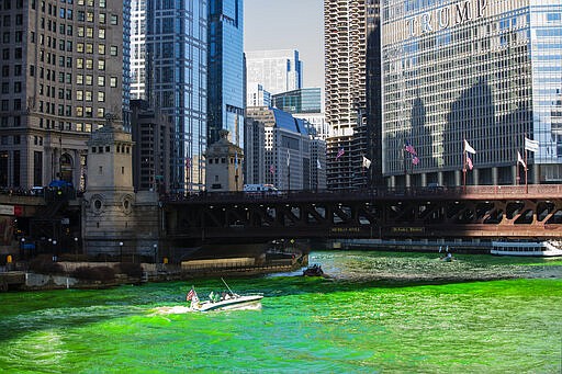 FILE - In this March 16, 2019 file photo, the Chicago River is dyed green for St. Patrick's Day in Chicago. Chicago on Wednesday, March 11, 2020 joined the growing ranks of cities across the United States to cancel its Saturday St. Patrick's Day Parade amid concerns about the coronavirus. The city will not be dyeing the river green either. For most people, the new coronavirus causes only mild or moderate symptoms, such as fever and cough. For some, especially older adults and people with existing health problems, it can cause more severe illness, including pneumonia.( James Foster/Chicago Sun-Times via AP File)