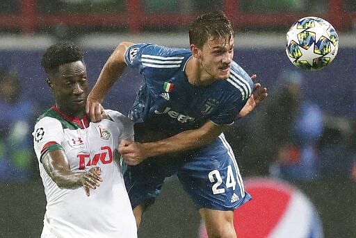 FILE - In this Nov. 6, 2019, file photo, Juventus' Daniele Rugani, right, fights for the ball with Lokomotiv's Eder during a Champions League soccer match at the Lokomotiv Stadium in Moscow, Russia. Italian soccer club Juventus announced on Wednesday, March 11, 2020, that defender Daniele Rugani has tested positive for new coronavirus. Rugani, who is also an Italy international, is the first player in Italy&#146;s top soccer division to test positive but Juventus stressed that the 25-year-old has no symptoms.  (AP Photo/Pavel Golovkin, File)