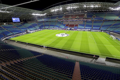 In this Tuesday, March 10, 2020 photo the empty stadium is pictured prior to the Champions League round of 16, 2nd leg soccer match between RB Leipzig and Tottenham Hotspur in Leipzig, Germany. Due to the new coronavirus outbreak several upcoming matches of the German Bundesliga will take place without the attendance of spectators. For most people, the new coronavirus causes only mild or moderate symptoms, such as fever and cough. For some, especially older adults and people with existing health problems, it can cause more severe illness, including pneumonia. (AP Photo/Michael Sohn)