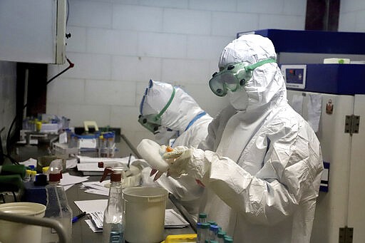 In this Tuesday, March, 10, 2020 photo, paramedics test samples taken from patients suspected of being infected with the new coronavirus, at a laboratory in the southwestern city of Ahvaz, Iran. For most people, the new coronavirus causes only mild or moderate symptoms, such as fever and cough. For some, especially older adults and people with existing health problems, it can cause more severe illness, including pneumonia. (Amin Nazari/ISNA via AP)