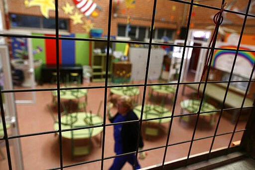 A closed school in Rivas Vaciamadrid, Spain, Wednesday, March 11, 2020. Spain's health minister on Monday announced a sharp spike in coronavirus cases in and around the national capital, Madrid, and said all schools in the region, including kindergartens and universities, will close for two weeks from Wednesday. For most people, the new coronavirus causes only mild or moderate symptoms, such as fever and cough. For some, especially older adults and people with existing health problems, it can cause more severe illness, including pneumonia. (AP Photo/Manu Fernandez)