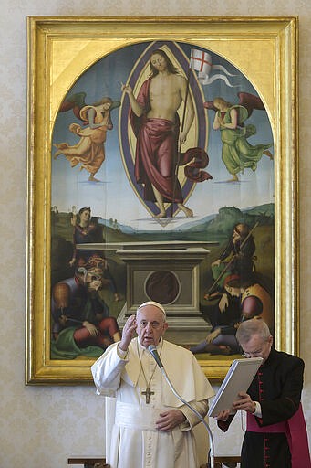 Pope Francis delivers his blessing as he holds his general audience at the Vatican, Wednesday, March 11, 2020.  Pope Francis held his weekly general audience in the privacy of his library as the Vatican implemented Italys drastic coronavirus lockdown measures, barring the general public from St. Peters Square and taking precautions to limit the spread of infections in the tiny city state. For most people, the new coronavirus causes only mild or moderate symptoms, such as fever and cough. For some, especially older adults and people with existing health problems, it can cause more severe illness, including pneumonia. (Vatican News via AP)