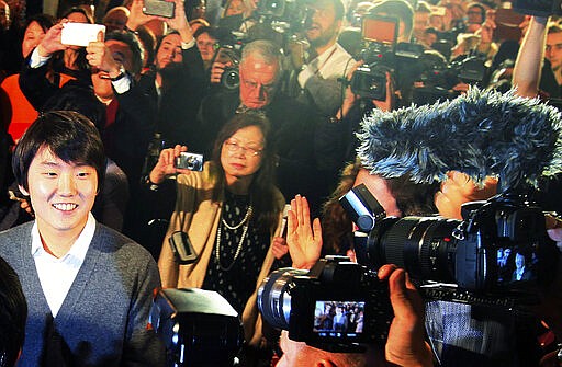 FILE - In this Oct. 20, 2015 file photo, South Korean pianist Seong-Jin Cho,left, smiles after being named the winner of the 17th International Frederic Chopin Piano Competition in Warsaw, Poland. Culture authorities in Poland said Monday, March 9, 2020 that the 18th edition of the international Frederic Chopin Piano Competition will take place Oct. 2-23 in Warsaw with a large participation of pianists from Asia.  (AP Photo/Czarek Sokolowski/file)