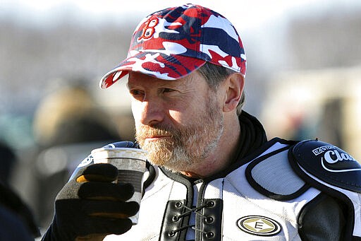 FILE - In this March 4, 2012 file photo, musher Jim Lanier drinks coffee before the start of the Iditarod Trail Sled Dog Race in Willow, Alaska. Lanier a 79-year-old retired pathologist and oldest musher in this year's race, withdrew, Wednesday, March 11, 2020, amid concerns over his own well-being. He's competed in a race in six decades. (Matt Tunseth/Chugiak-Eagle River Star via AP)