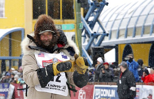 FILE - In this March 7, 2020 file photo, four-time Iditarod Trail Sled Dog Race champion Lance Mackey is shown before the ceremonial start of the Iditarod Trail Sled Dog Race in Anchorage, Alaska. The Anchorage Daily News reported Wednesday, March 11, 2020, that Mackey is giving his dogs CBD oil, which he says improves their recovery time. The race&#146;s head veterinarian, Stuart Nelson asked Mackey not to give CBD oil to his dogs.  Short for cannabidiol, CBD is a non-intoxicating molecule found in hemp and marijuana. (AP Photo/Mark Thiessen, File)