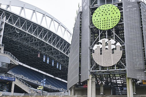 CenturyLink Field, where MLS soccer's Seattle Sounders and the XFL's Seattle Dragons play home games, sits empty, Wednesday, March 11, 2020, in Seattle.  In efforts to slow the spread of the COVID-19 coronavirus, Washington State Gov. Jay Inslee announced a ban on large public gatherings in three counties in the metro Seattle area. That decision impacts the Seattle Mariners, Seattle Sounders, and the XFL's Seattle Dragons home games. (AP Photo/Stephen Brashear)