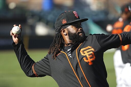 San Francisco Giants pitcher Johnny Cueto warms up during spring training baseball workouts for pitchers and catchers Wednesday, Feb. 12, 2020, in Scottsdale, Ariz. (AP Photo/Ross D. Franklin)