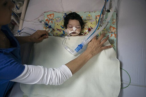 Nurse Nena Sreckovic, of the Novick Cardiac Alliance medical team, places a blanket over 40-day-old Yaqen as she recovers from heart surgery in the intensive care unit of the Tajoura National Heart Center in Tripoli, Libya, on Feb. 26, 2020. Medical trips by international doctors help prop up Libya&#146;s fragile health care system, which the World Health Organization has described as overburdened, inefficient and short of medicine and equipment. (AP Photo/Felipe Dana)