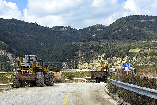 This Tuesday, March. 10, 2020 photo released by the Syrian official news agency SANA, shows workers removing barriers from the road that links Syria&#146;s coastal region with the northern city of Aleppo, in Latakia province, Syria. The reopening of the M4 highway that has been closed since 2012 is part of a deal reached earlier this month between Turkey and Russia that stopped a Russian-backed government offensive on the northwestern province of Idlib, the last rebel stronghold in the country. (SANA via AP)