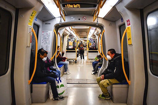 People wearing masks sit in a subway train in Milan, Italy, Wednesday, March 11, 2020. In Italy the government extended a coronavirus containment order previously limited to the country&#146;s north to the rest of the country beginning Tuesday, with soldiers and police enforcing bans. For most people, the new coronavirus causes only mild or moderate symptoms, such as fever and cough. For some, especially older adults and people with existing health problems, it can cause more severe illness, including pneumonia. (Claudio Furlan/LaPresse via AP)