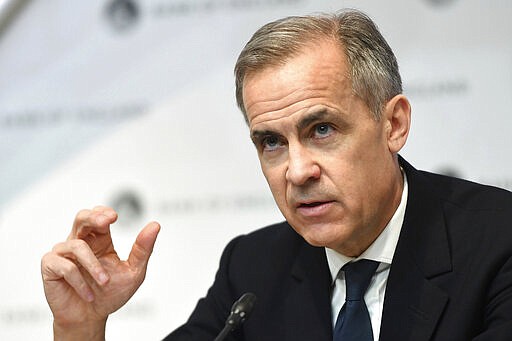 Governor of the Bank of England, Mark Carney, speaks during a news conference at Bank Of England, in London, Wednesday, March 11, 2020. The Bank of England has cut its key interest rate by half a percentage point to 0.25%, as an emergency measure in response to the outbreak of the COVID-19 virus. (Peter Summers/Pool Photo via AP)